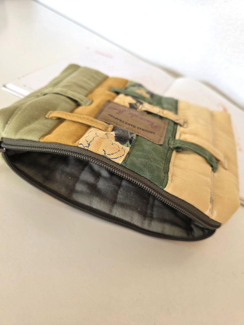 Side angle photo showing the depth and structure of the upcycled denim cosmetic pouch. Reinforced seams and careful tailoring highlight quality, durability and handmade craftsmanship.