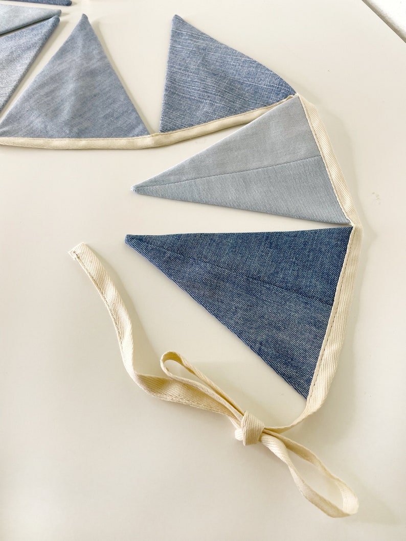 The fabric flags are sewn to a sturdy natural cotton cord with an extra 50 cm (~20 in) on each side for hanging.