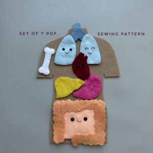 May include: A set of 7 PDF sewing patterns for creating a felt human body with different organs. The organs are colorfully designed with smiling faces and include the lungs, heart, liver, stomach, and intestines. The pattern includes a bone for the rib cage.