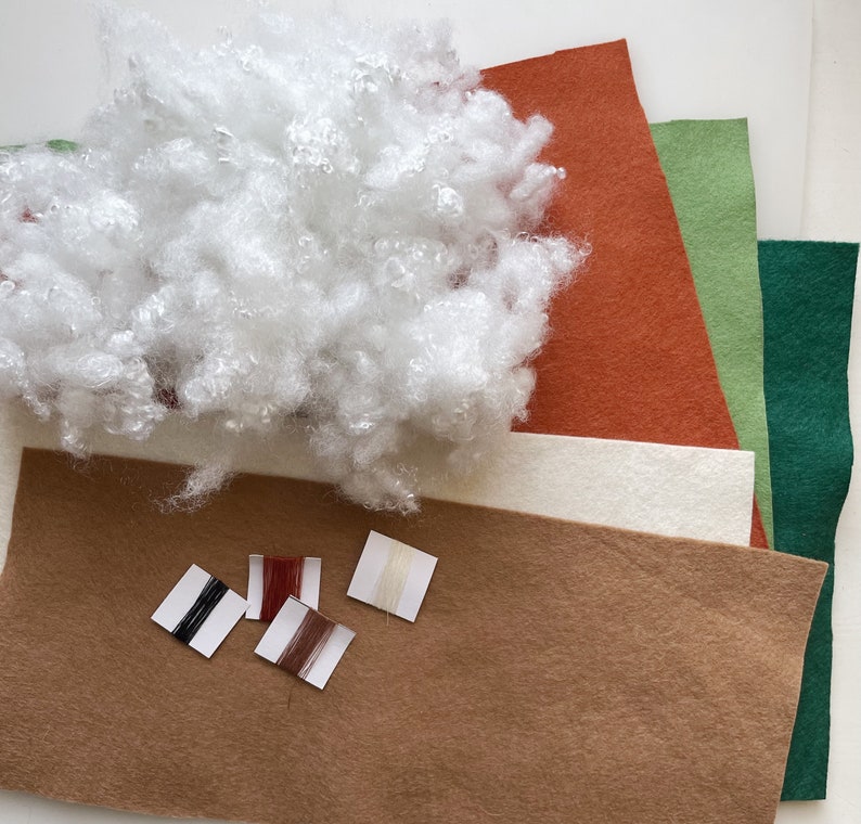 May include: A craft kit with brown, white, green, and orange felt fabric, white stuffing, and four spools of thread in black, red, brown, and white.