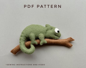 May include: PDF pattern for a felt chameleon toy sitting on a branch. The chameleon is green with a white eye and a brown branch. The pattern includes sewing instructions and a video.