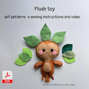 May include: A handmade plush toy with a smiling face, rosy cheeks, and leaf-shaped accents. The toy is brown and tan with green leaves. The image includes the text "Plush toy" and "pdf patterns + sewing instructions and video".
