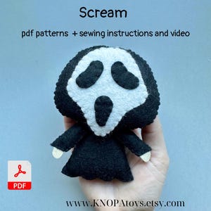 May include: A felt Scream doll with a white mask and black robe. The doll has a wide open mouth and large eye holes. The text "Scream" is above the doll, with "pdf patterns + sewing instructions and video" below. The Etsy shop URL is at the bottom.