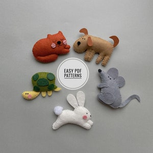 May include: Five felt animal toys: a red cat, a brown dog, a green turtle, a white rabbit, and a gray mouse. The toys are arranged in a circle on a gray background. The text "EASY PDF PATTERNS" is written in a white circle in the center of the image.