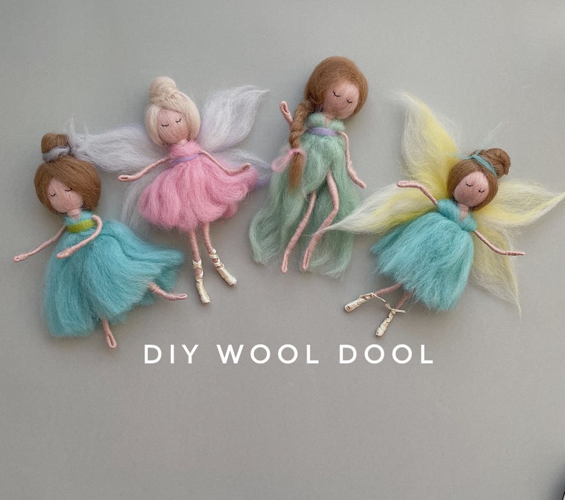 May include: Four handmade felt fairy dolls with wings. The fairies are wearing pink, green, and blue dresses. The dolls are arranged on a light gray background. DIY WOOL DOOL is written below the dolls.