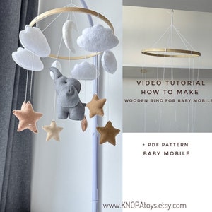 May include: A DIY baby mobile kit featuring a wooden ring, felt clouds, stars, and an elephant. The kit includes a PDF pattern and a video tutorial on how to make the mobile.