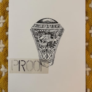 May include: Black and white illustration of a ring with intricate details. The ring features the text "USMA" and "WITH VISION WE LEAD". The word "PROOF" is stenciled below the ring.