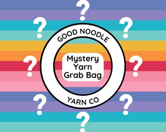 May include: A colorful graphic for a yarn product. The image features a white circle with the text "GOOD NOODLE YARN CO" and a central square that reads "Mystery Yarn Grab Bag." White question marks surround the circle against a rainbow striped background.