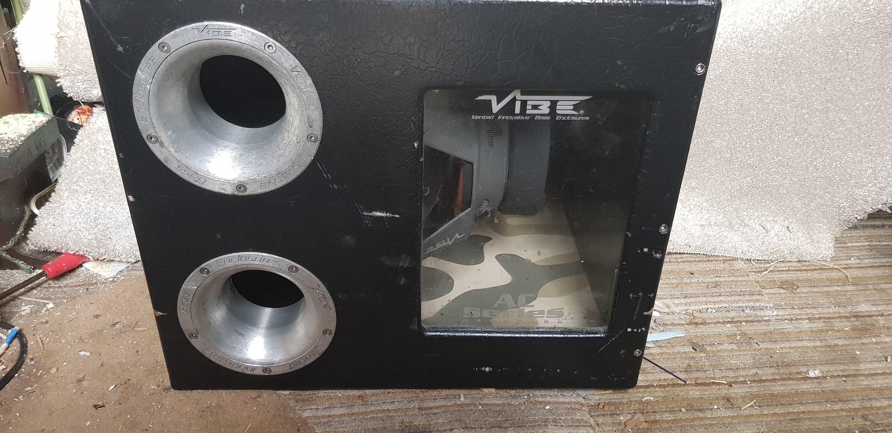 This is a vibe subwoofer that has a custom made box with glass window and camo wrapping . This is a used item