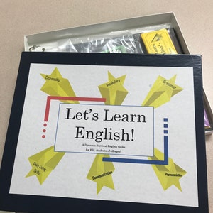 May include: A blue and yellow board game called "Let's Learn English!" with a star-shaped design. The game is a dynamic survival English game for ESL students of all ages. The game includes categories such as citizenship, vocabulary, grammar, daily living skills, communication, and pronunciation.