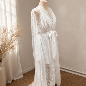 White lace robe for bride with romantic train detail