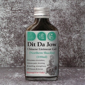 May include: A glass bottle with a silver cap, labelled "Dit Da Jow Chinese Liniment Gel (Northern Shaolin)". The label features text and a dragon illustration. The bottle contains 100ml of liquid.