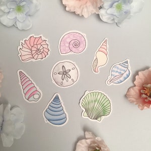 May include: A set of nine colorful seashell stickers. The stickers feature a variety of seashells in different shapes and sizes, including a sand dollar, a conch shell, and a scallop shell. The stickers are perfect for adding a touch of whimsy to any project.