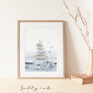 May include: A watercolor painting of a stack of gray and brown stones with blue butterflies flying around them. The stones are stacked in a pyramid shape and are surrounded by a blue and white watercolor background. There are blue hydrangeas at the base of the stones.