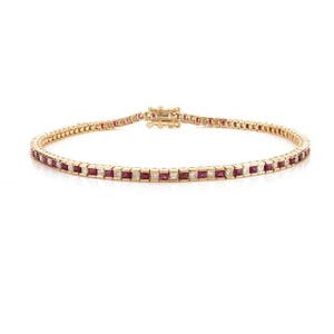 May include: A gold bracelet with alternating square-cut red gemstones and small white gemstones. The bracelet has a secure clasp and is displayed on a white background. The jewelry piece is elegant and suitable for special occasions.