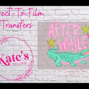 May include: Direct-to-film transfers featuring a teal alligator with the words "AFTER WHILE" in pink, accented by yellow and pink stars. The image also includes a pink circular logo with the text "Kate's EST. 2022".