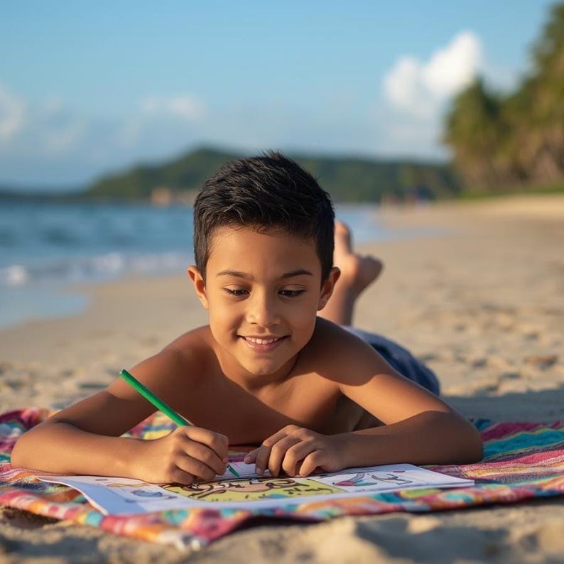 May include: A young person is lying on a colorful beach towel, drawing with a green pencil on a coloring book. The scene is set on a sandy beach with the ocean and a blue sky in the background.