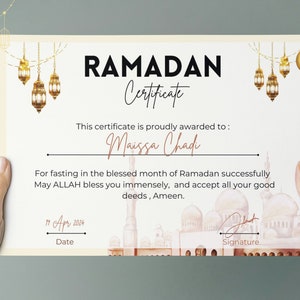May include: A printable Ramadan certificate with a watercolor illustration of a mosque and lanterns. The text reads "Ramadan Certificate" and "This certificate is proudly awarded to: Maissa Chad" and "For fasting in the blessed month of Ramadan successfully May ALLAH bless you immensely, and accept all your good deeds, Ameen." The date is "19 Apr 2024".