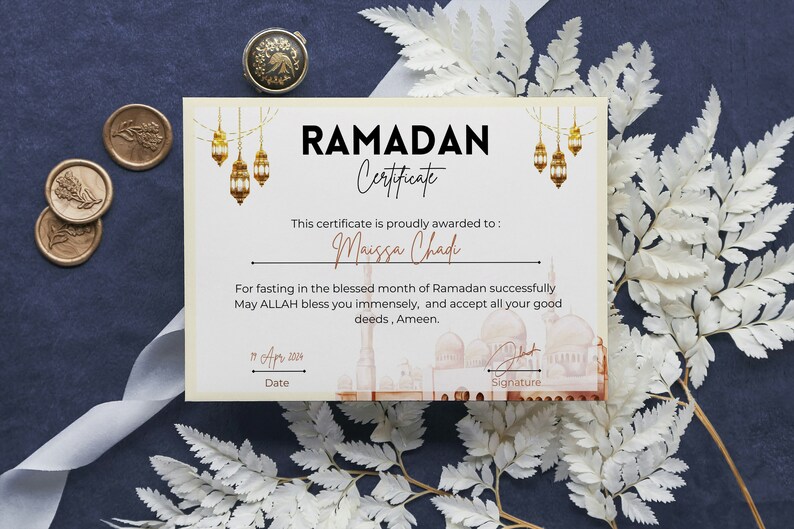 May include: A certificate with a gold and white design, featuring a mosque and lanterns. The text reads "RAMADAN Certificate" and "This certificate is proudly awarded to: Maissa Chad". The date is "11 Apr 2004".