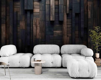 May include: A white modular sofa with a tufted design sits in front of a dark wood wall. The sofa has a chaise lounge and a coffee table with a book and a glass on top.