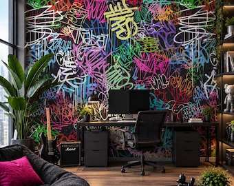 May include: A wall mural featuring a dense, multi-colored graffiti pattern with overlapping tags in neon pink, green, blue, and yellow on a black background. The design covers the entire wall behind a black desk, chair, and computer monitor setup.