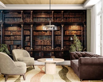 May include: A room featuring a large, detailed bookshelf mural. The room includes two beige armchairs, a brown leather sofa, a round wooden coffee table, and a patterned rug. A small plant and a lamp are also visible.