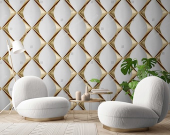 May include: Two white rounded chairs with gold bases sit before a wall featuring a repeating pattern of white leaf-shaped panels separated by gold geometric accents. A gold floor lamp, two gold nesting tables with vases, and a green plant are present.