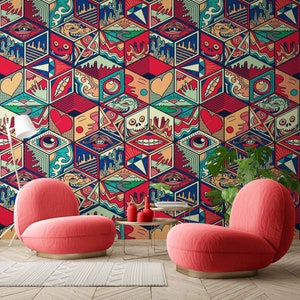 May include: Two bright red armchairs with rounded backs and a gold base, placed in front of a colorful geometric patterned wall. The wall features a repeating pattern of red, blue, yellow, and green geometric shapes with various abstract designs.