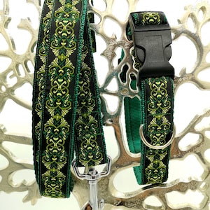 May include: A black and green patterned dog collar and leash set. The leash has a silver clasp, and the collar features a black plastic buckle and a metal ring. The pattern includes green and yellow floral designs.