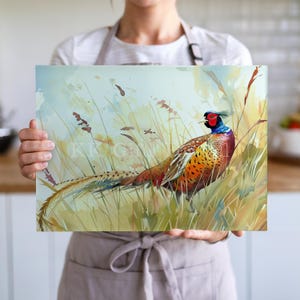 Peut inclure: Une impression aquarelle d'un faisan dans les hautes herbes. L'oiseau arbore un plumage orange, marron et rouge vif, une tête bleue et de longues plumes de queue. L'arrière-plan présente des tons doux de jaune et de vert, suggérant un cadre naturel extérieur.