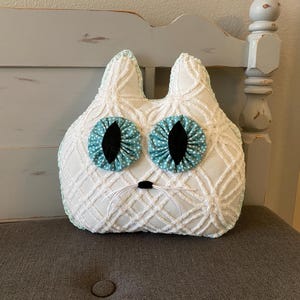 Adorable stuffed cat pillow made from chenille blanket with yo-yo fabric eyes