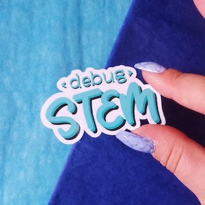 May include: A white sticker with the text "<debug> STEM" in turquoise blue lettering. The sticker is held by a hand with light blue and white marbled nail polish.