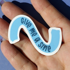 Könnte beinhalten: Ein blauer und weißer Aufkleber mit dem Text "Give me a slime" in einer geschwungenen, handschriftlichen Schrift.