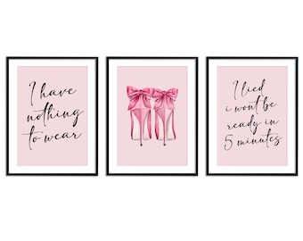 May include: Set of three framed art prints with pink backgrounds and black frames. One print reads "I have nothing to wear", another features pink high heels with bows, and the third says "I lied I won't be ready in 5 minutes."