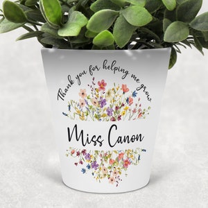 May include: White ceramic planter with a floral design and the text "Thank you for helping me grow" and "Miss Canon".