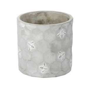 May include: A grey concrete planter with a honeycomb pattern and bee designs.