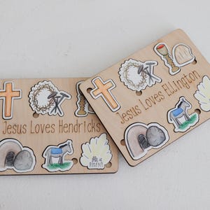 May include: Two wooden boards with images of religious symbols and the text "Jesus Loves Hendricks" and "Jesus Loves Ellington".