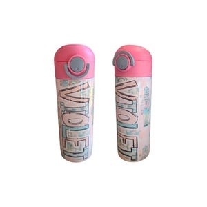 May include: Two pink water bottles with a light pink and blue design. The bottles have the word "Hello" written on them in a stylized font.