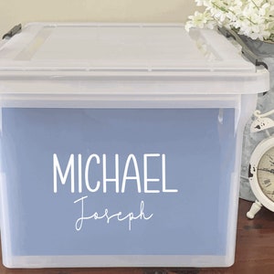 May include: A clear plastic storage bin with a light blue label that says "MICHAEL Joseph" on it.