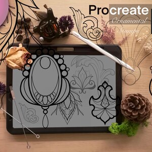 May include: A digital tablet displaying 20 Procreate ornamental stamps. The stamps are black and white and feature intricate designs. The tablet is on a wooden surface with a stylus, a tattoo machine, and other decorative items.
