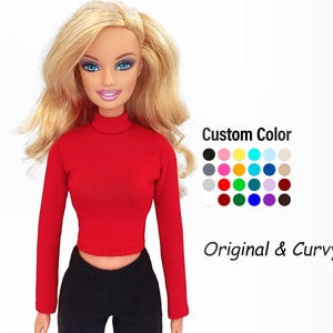 May include: A doll wearing a red long-sleeved turtleneck top and black pants. The doll has blonde hair and blue eyes. Text on the image reads "Custom Color" and "Original & Curvy", with a color chart.