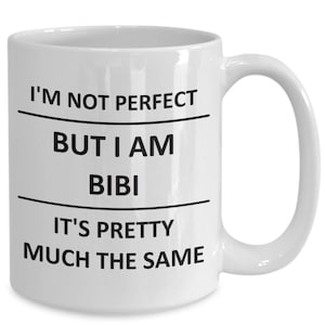 May include: White ceramic coffee mug with black text that reads "I'm not perfect but I am bibi it's pretty much the same".