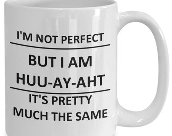 May include: White ceramic coffee mug with black text that reads "I'm not perfect but I am huu-ay-aht it's pretty much the same."