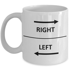 May include: White ceramic coffee mug with black text and arrows. The text reads "RIGHT" and "LEFT" with an arrow pointing to the right above the word "RIGHT" and an arrow pointing to the left below the word "LEFT".