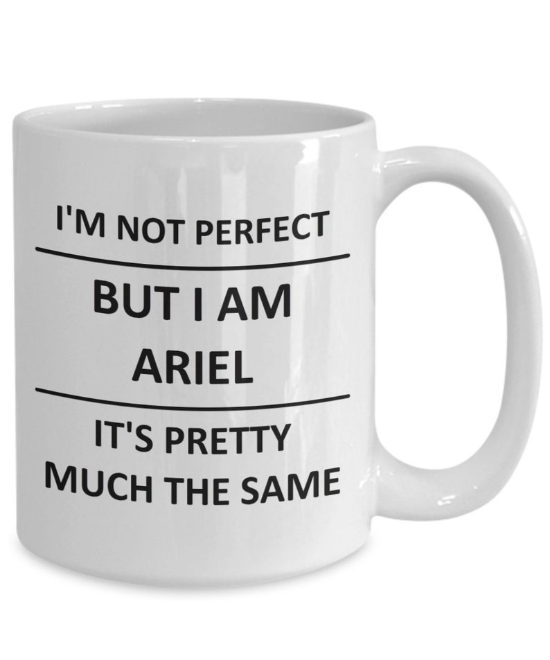 May include: White ceramic coffee mug with black text that reads "I'm not perfect but I am Ariel it's pretty much the same."