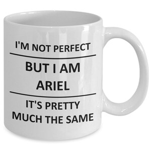 May include: White ceramic coffee mug with black text that reads "I'm not perfect but I am Ariel it's pretty much the same."