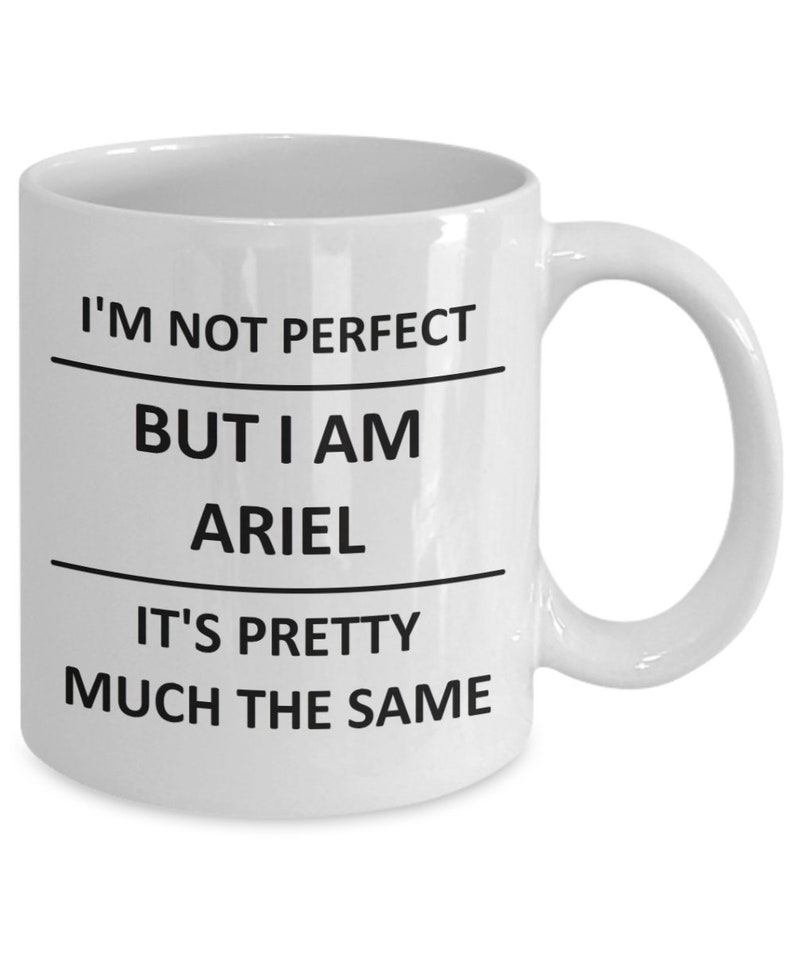 May include: White ceramic coffee mug with black text that reads "I'm not perfect but I am Ariel it's pretty much the same."