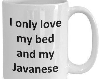 May include: White ceramic coffee mug with black text that reads "I only love my bed and my Javanese".
