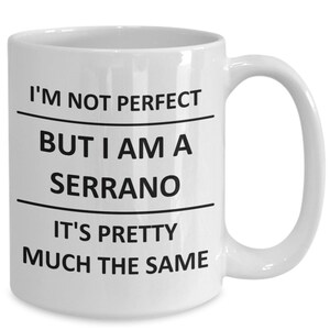 May include: White ceramic coffee mug with black text that reads "I'm not perfect but I am a serrano it's pretty much the same".