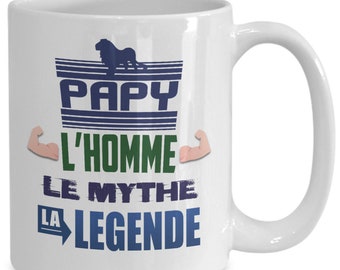 May include: White ceramic coffee mug with a blue and green graphic design that says "Papy L'homme Le Mythe La Legende" with a lion illustration.
